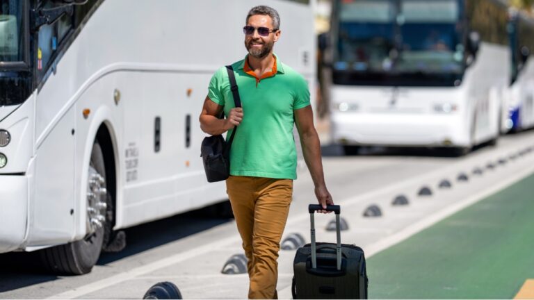 Man 40s tourist on summer vacation. Traveler trip luggage. Summer tour. Traveler enjoy summer trip. Hispanic tourist traveler walking on street. Tourist with suitcase in tropical city