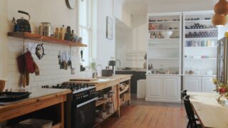 Empty, room and kitchen with equipment in home for meal prep, cooking and culinary utensils. Design, furniture and rustic interior with pantry, storage and kitchenware for house decor and appliances