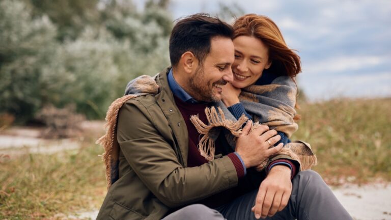 Loving couple spending autumn day together in nature.