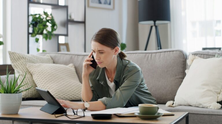 Woman, tablet and documents with phone call at house for enquiry, financial debt and payment error. Confused, person and paperwork with mobile to contact bank, finance statement and concern for bills