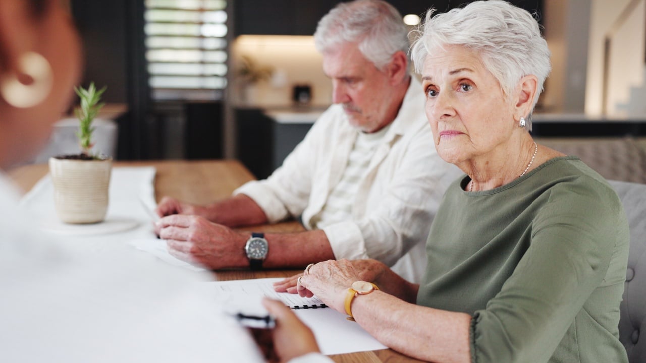 senior couple or discussion with agent for real estate, property purchase or insurance policy.