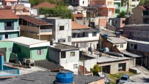 Dense residential neighborhood with simple houses in a Brazilian favela or community. Concept of urbanization, social inequality, and life in the outskirts of Brasil.