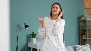 Young woman suffering from noisy at home