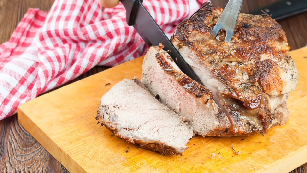 grilled meat sliced with spices on a cutting board in the kitchen background