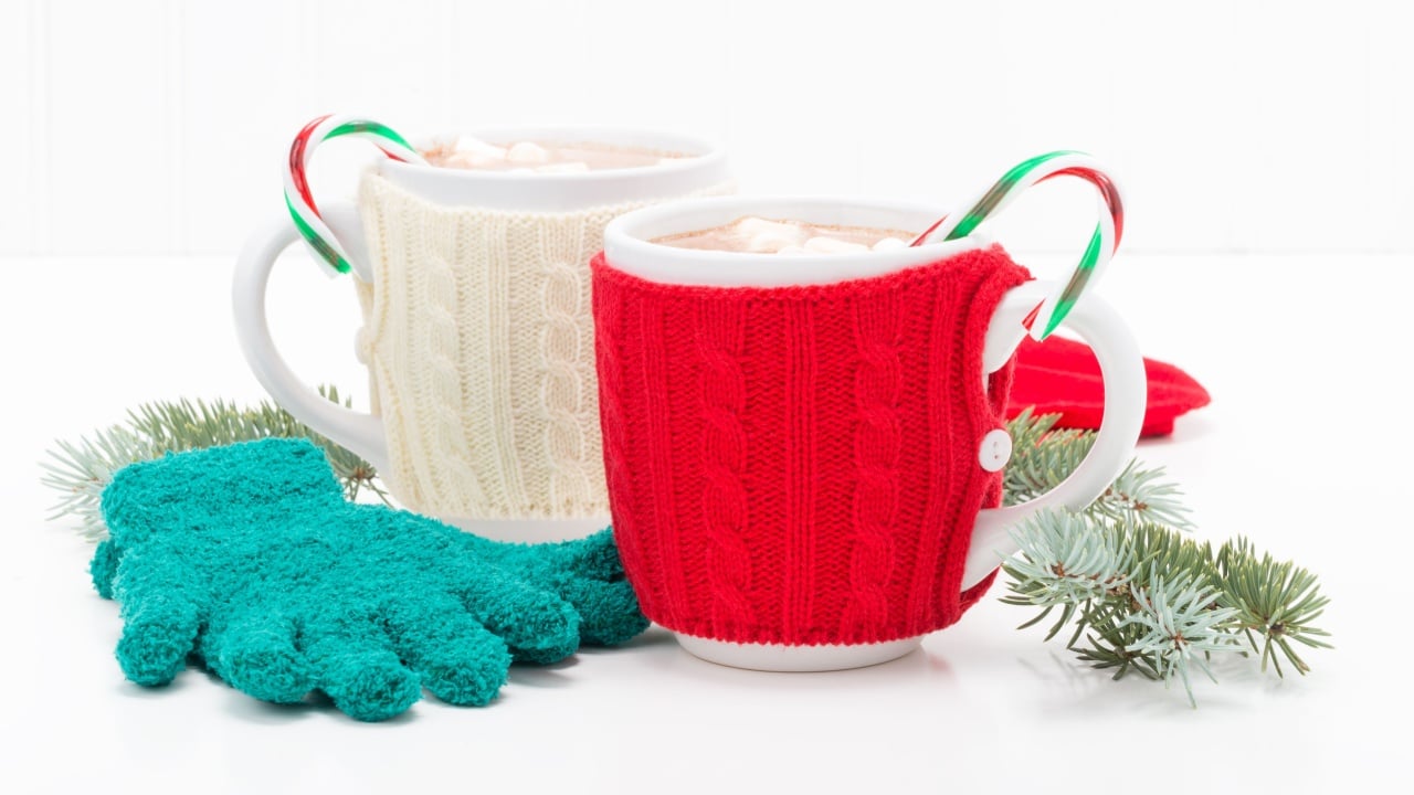 Two mugs of hot chocolate flavored with candy canes.
