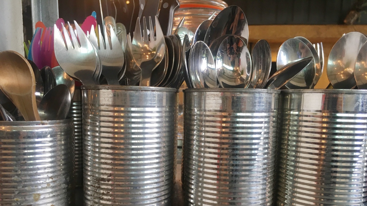 Cutlery in steel cans on the kitchen table