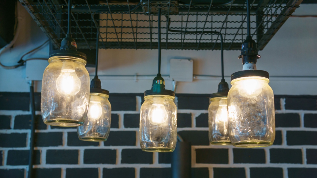 electricity light bulb glowing in the transparent vase hanging on the ceiling for abstract background or special occasion background.