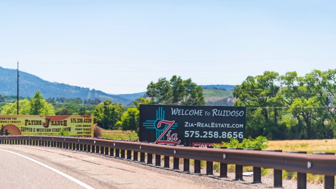 Ruidoso, USA - June 8, 2019: New Mexico countryside small city town street road with welcome sign to resort village and real estate