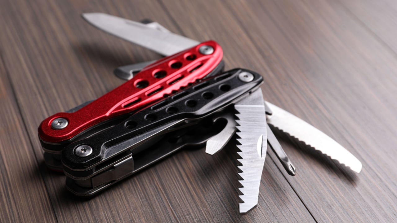 Modern compact portable multitool on wooden table