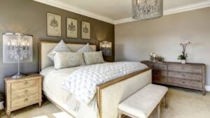 Luxury bedroom interior with carved wood bed, dresser and nightstands