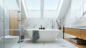Stylish bathroom interior design with marble panels. Bathtub, towels and other personal bathroom accessories. Modern glamour interior concept. Roof window. Template.