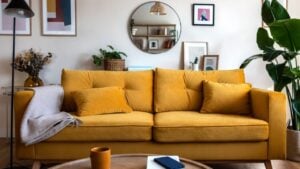 Front view of yellow couch in living room apartment interior.