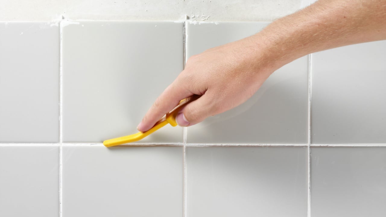 MAN TILING A WALL