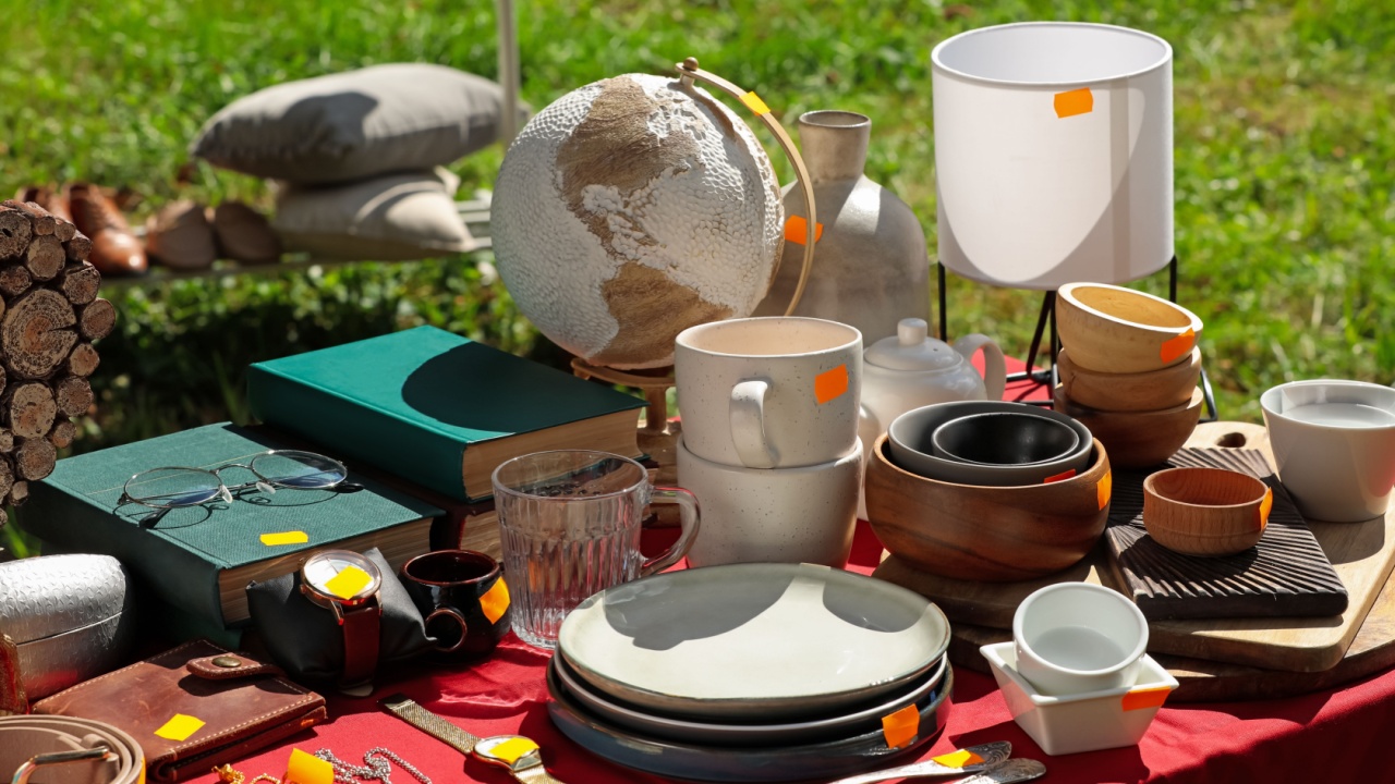 Many different items on table outdoors. Garage sale