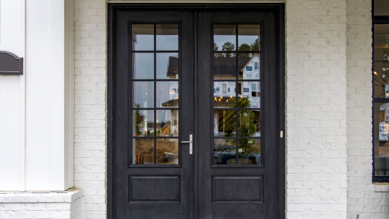 A modern black door of a house in a suburban area