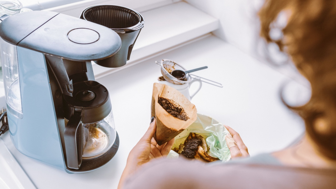 Close-up, different angles, young woman throws away coffee grounds, from coffee machine, into container with food waste, in home kitchen. Waste sorting at home, recycling, composting