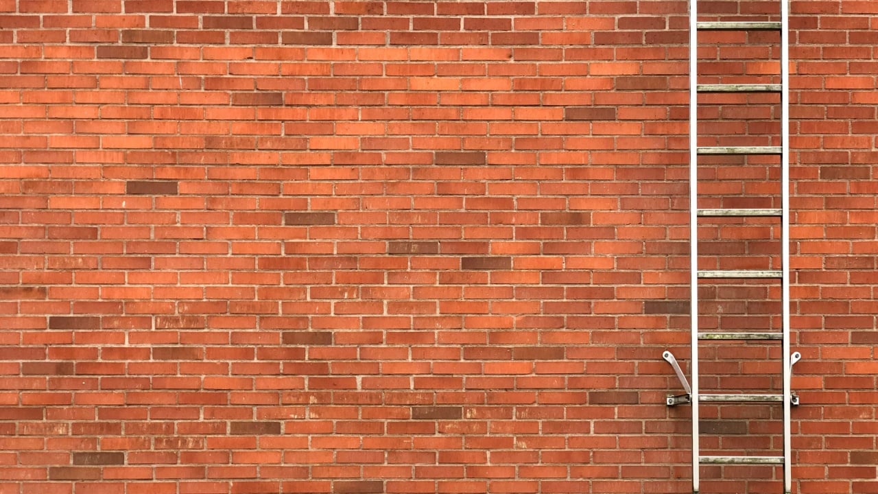 Safety exit ladders on brick wall