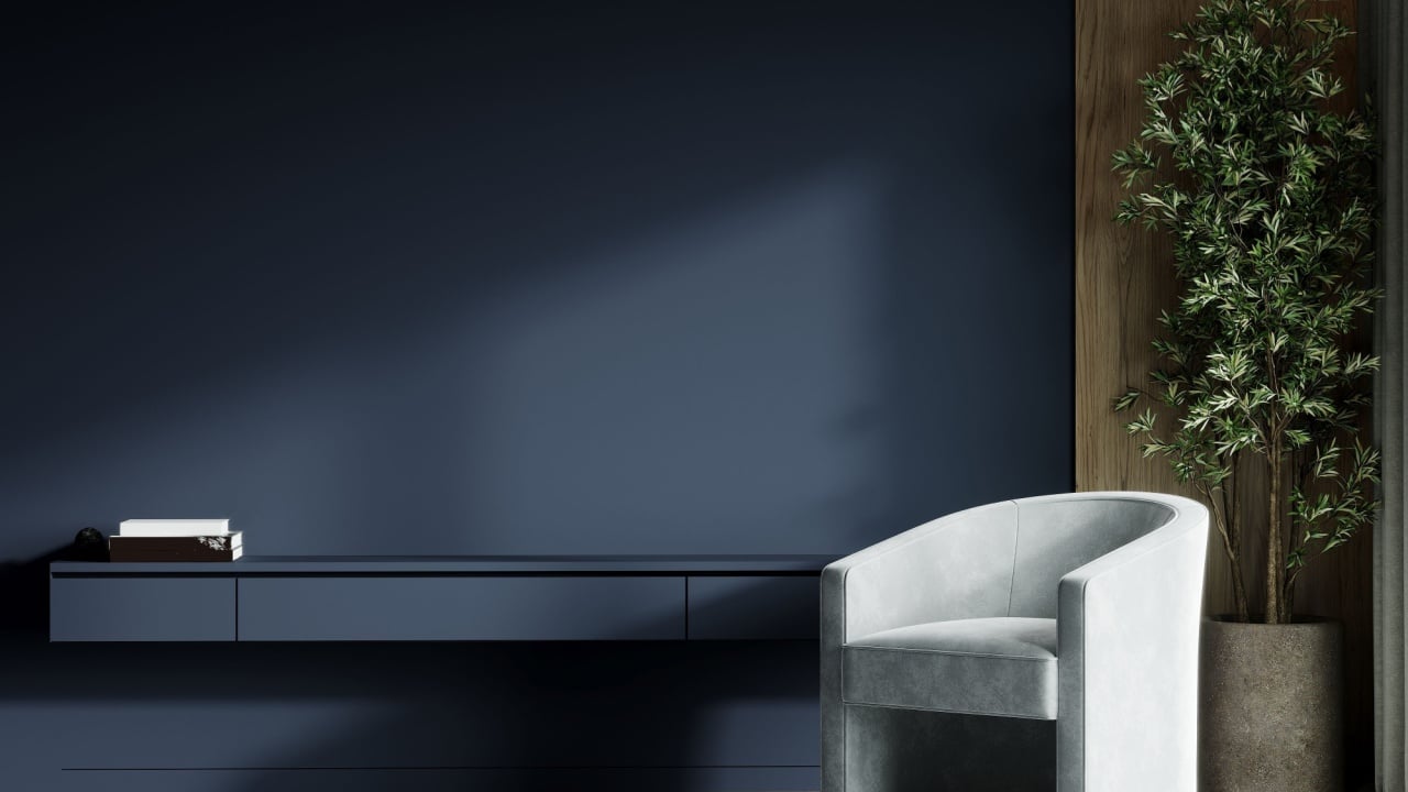 Deep dark livingroom with blue navy empty paint walls and gray chair. Accent indigo cyan colors. Mockup for art or picture. Modern premium interior design room - minimal lounge reception.