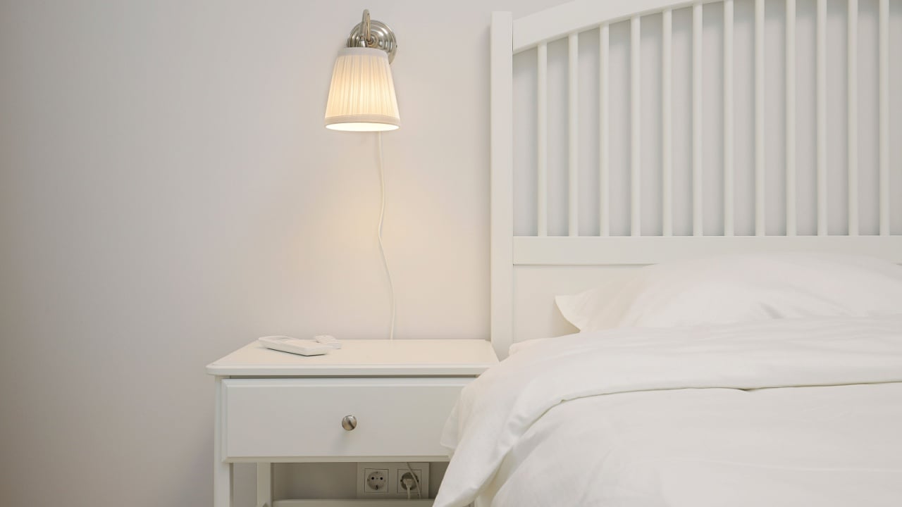 Bedside table and sconce in the bedroom interior