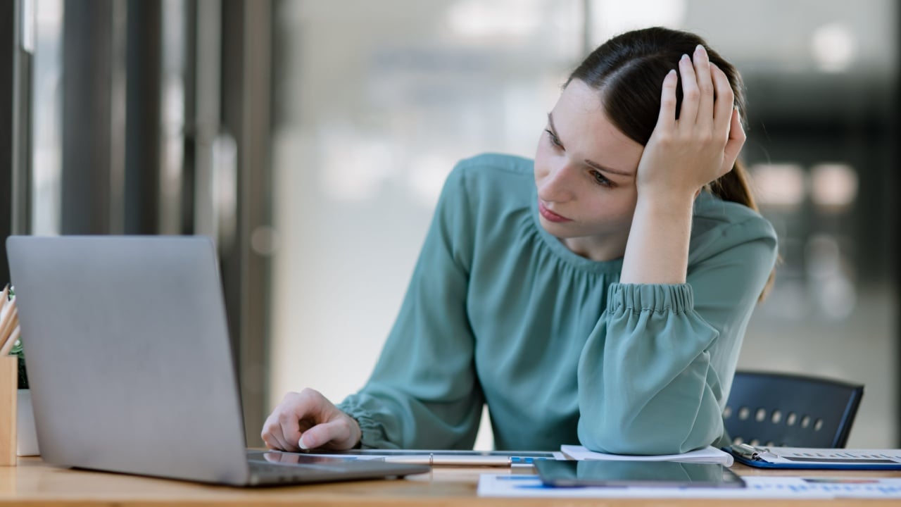 Businesswoman stressed and tired from work sitting in office desk, Young women stress from overwork.