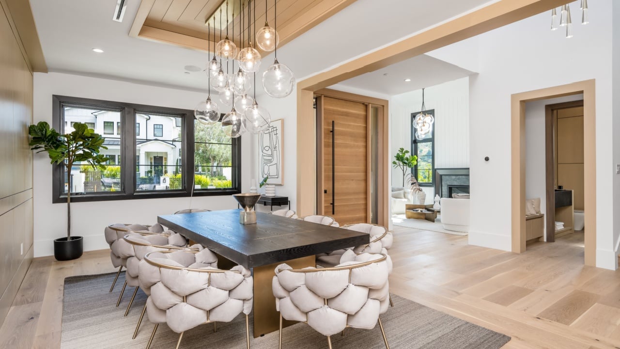 OXNARD, US - Apr 13, 2022: A modern interior featuring a stylish dining room with a wooden table and four chairs set up for a meal