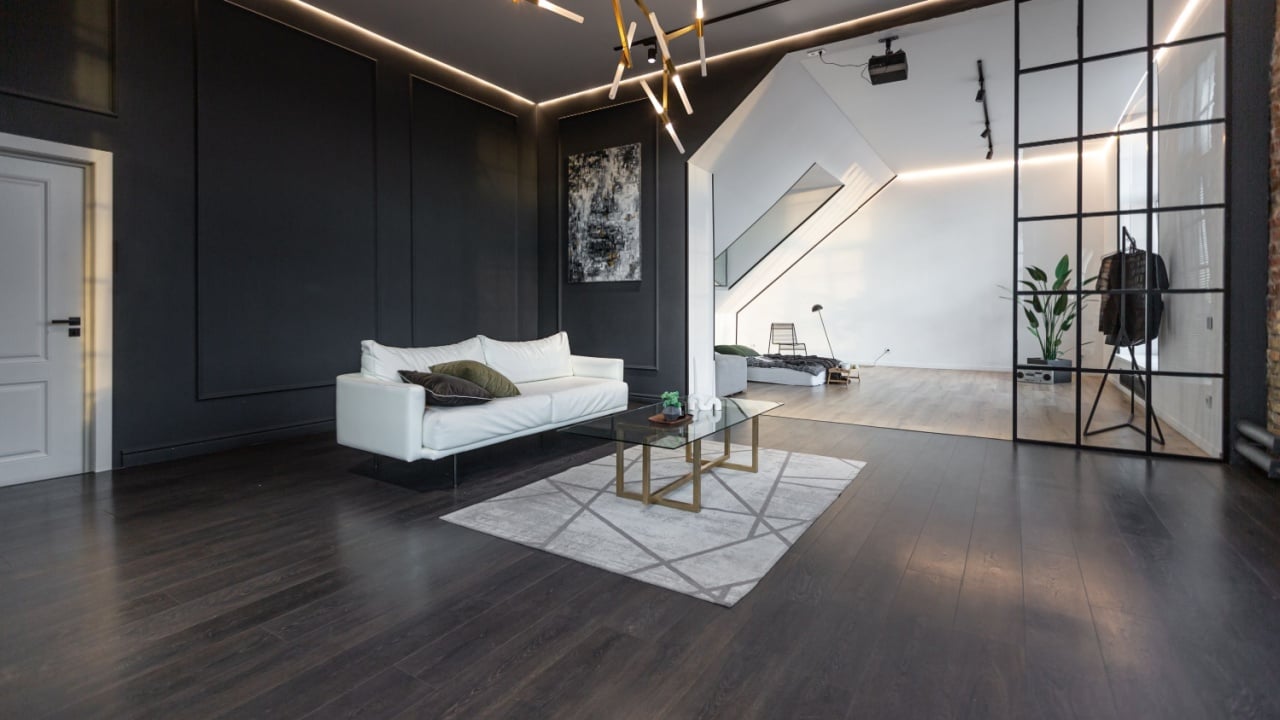 minimalistic stylish interior of luxury apartment with white stylish bedroom and dark living room. modern apartments with an open layout during the day without people and amazing sun rays