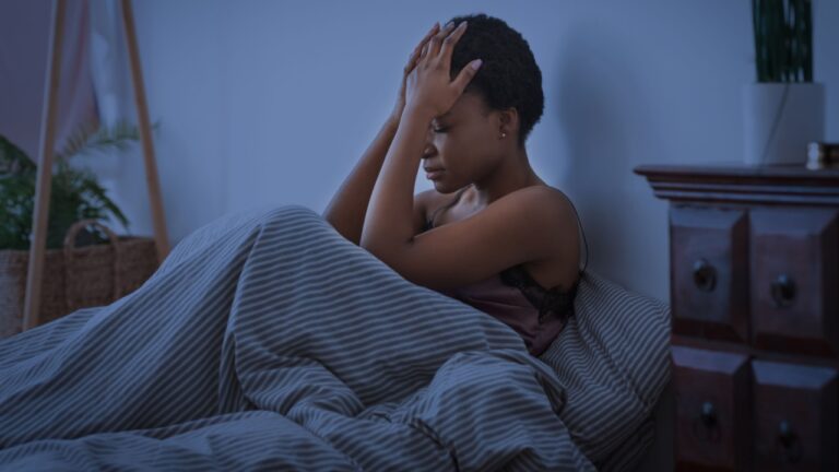 Bad thoughts and dreams. Upset african american girl press hands to head and cannot sleep
