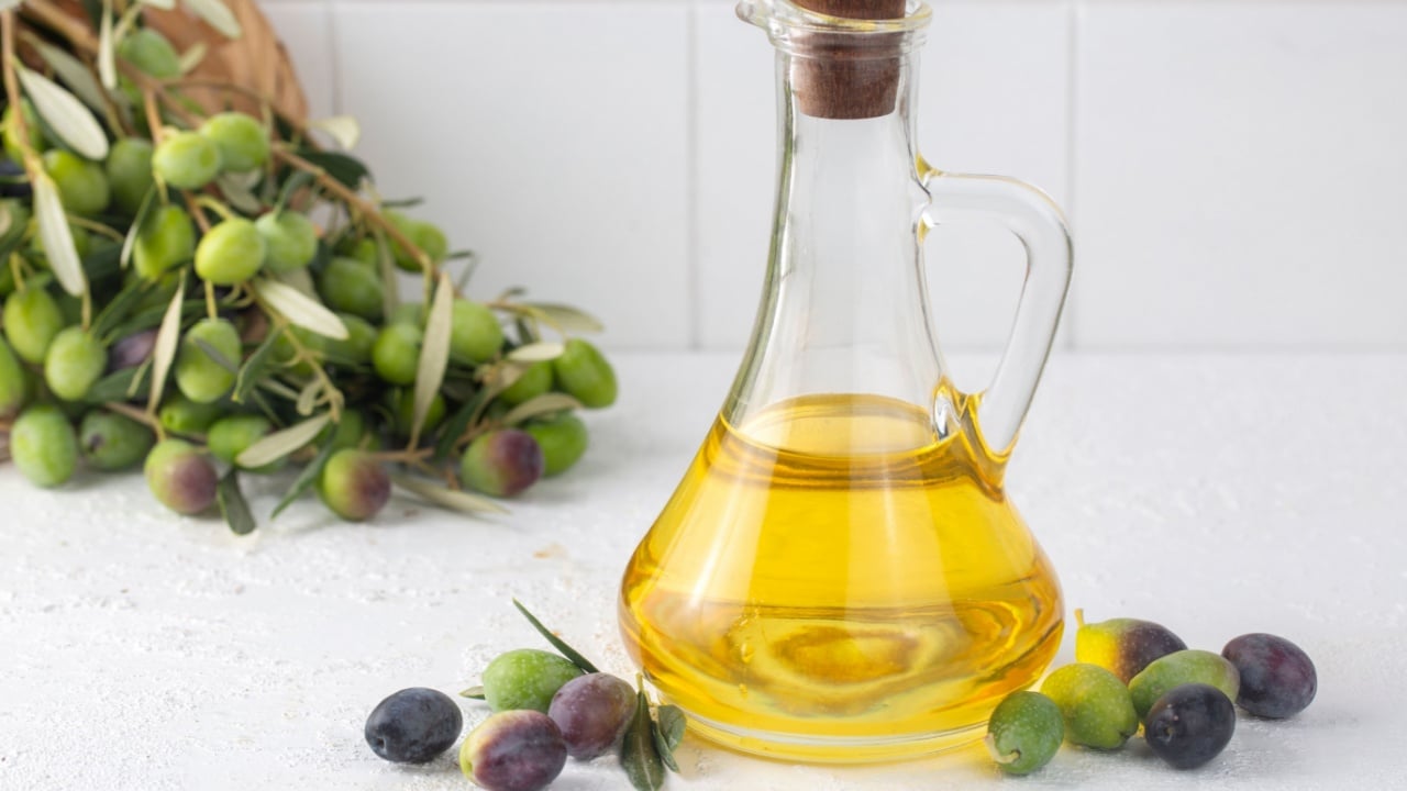 Green fresh olive and olive oil isolated.