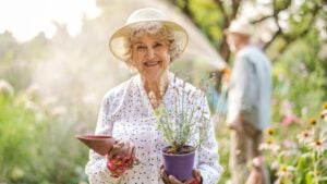 Smiling senior woman in her garden on a sunny day