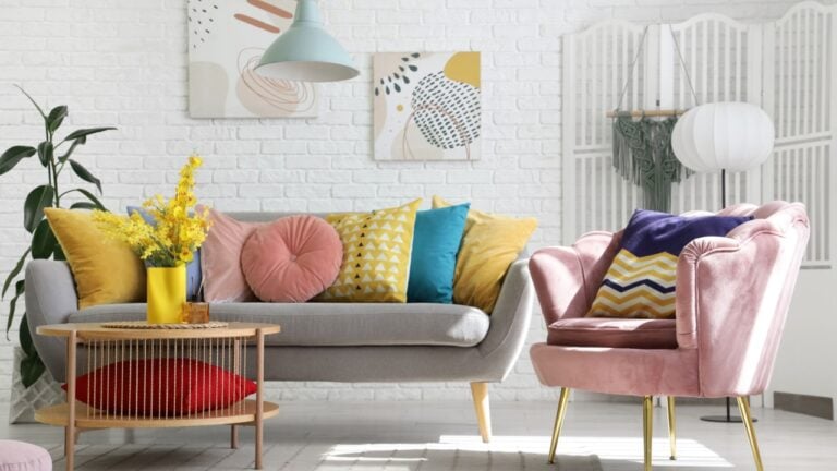 Interior of stylish living room with pink armchair, sofa and table