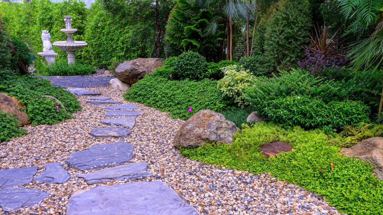 Stone stepping Walkway among lawn in a Japanese style garden. Landscaping in the garden