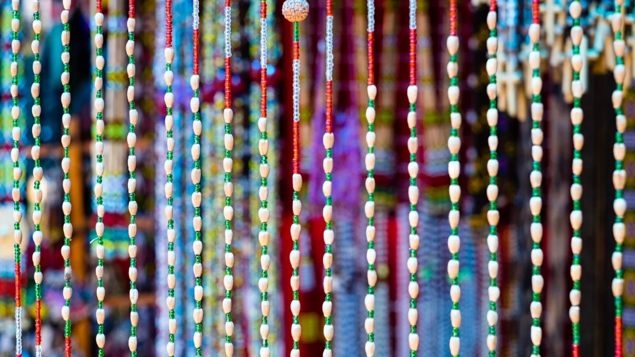 Handcrafted or handmade curtain of beads in a colorful background. Each string is a combination of plastic, bamboo, and seeds. One of the native products of South Cotabato, Philippines.