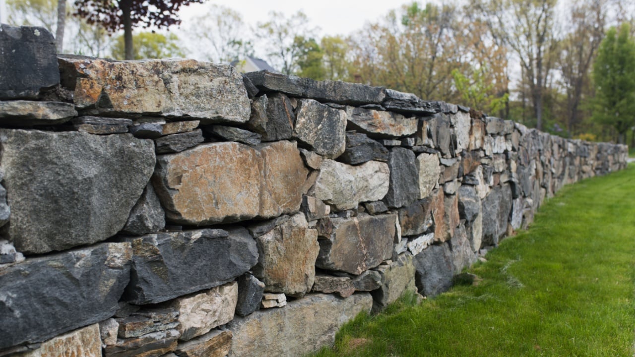 Beautiful stone wall in residential neighborhood.