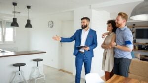 Young couple with a real estate agent. Buying a new house.