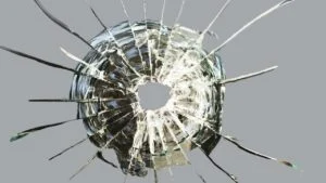 glass cracked by bullet impacts