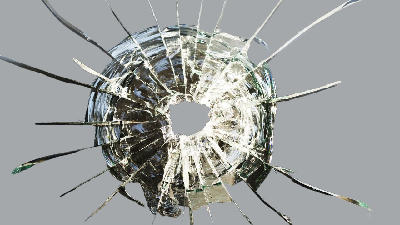 glass cracked by bullet impacts