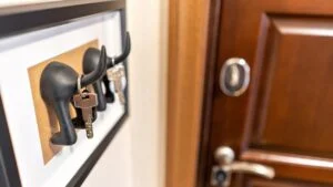 Organize your life, insurance and security concept. house with keys, hanging on hooks