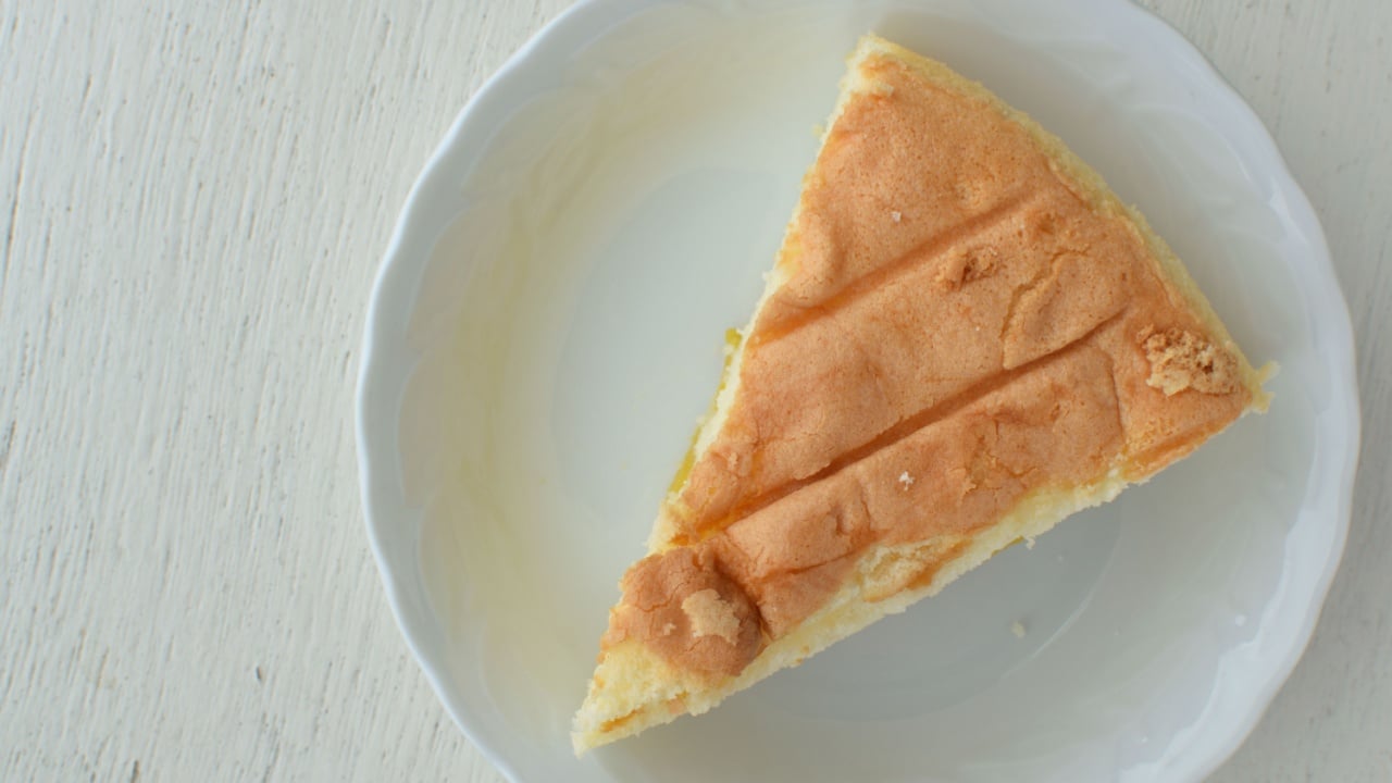  Jackfruit cake on white plate and on white wood table.