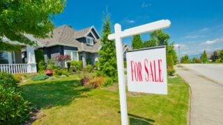 House, sign for sale for big custom made luxury house in the suburbs of Vancouver, Canada.