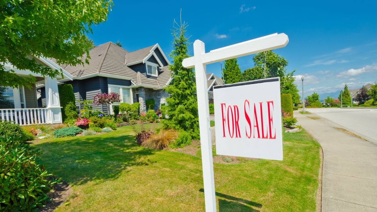 House, sign for sale for big custom made luxury house in the suburbs of Vancouver, Canada.