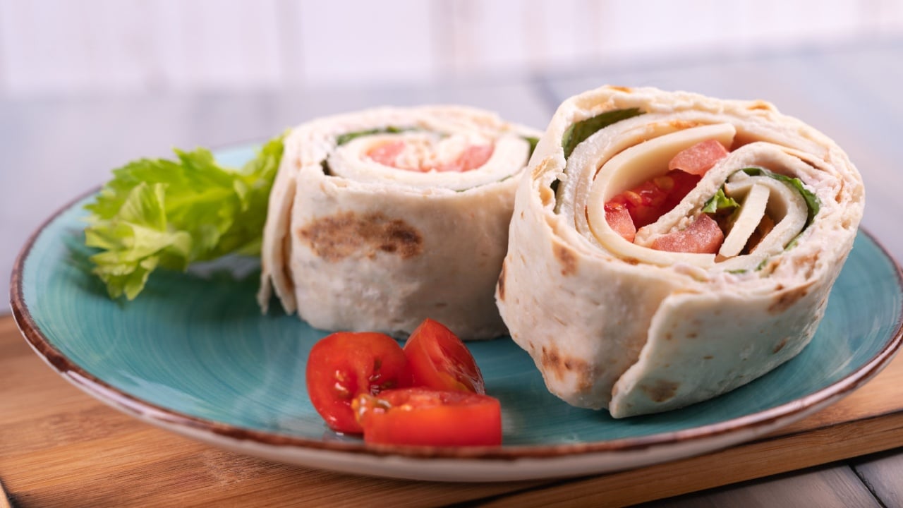 Turkey Roll Ups with cheese and vegetables, Close-up of delicious appetizer. Tortilla pieces.