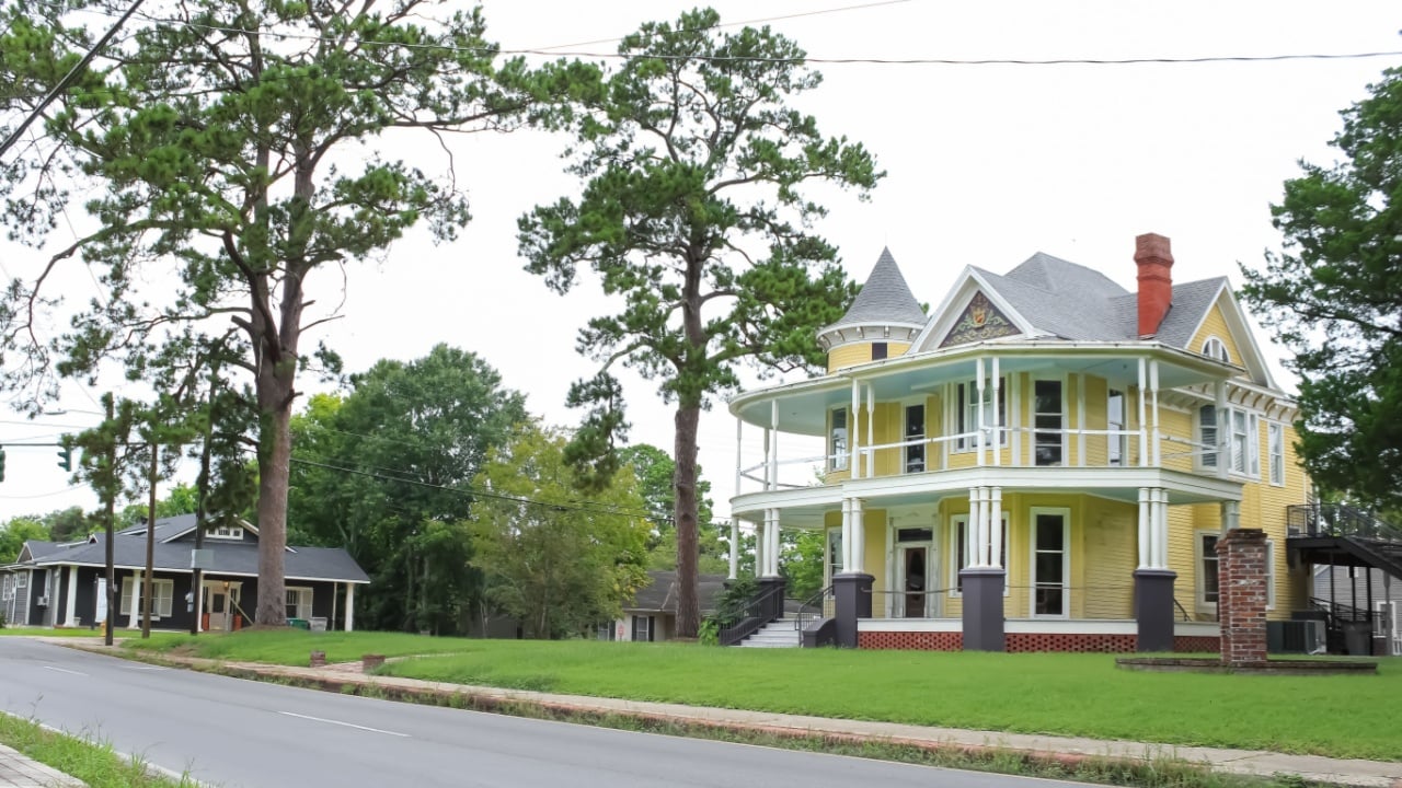 Opelousas, Louisiana United States - September 5 2022: a historic home with a pine tree in the yard 