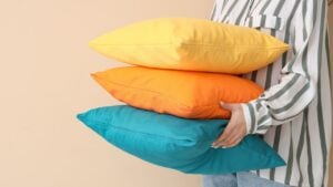 Woman with bright pillows on beige