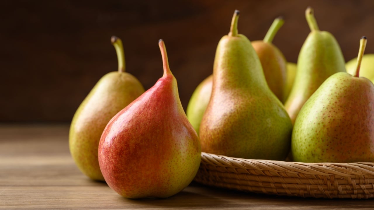 Pear fruit in natural basket on wooden background, Healthy fruit
