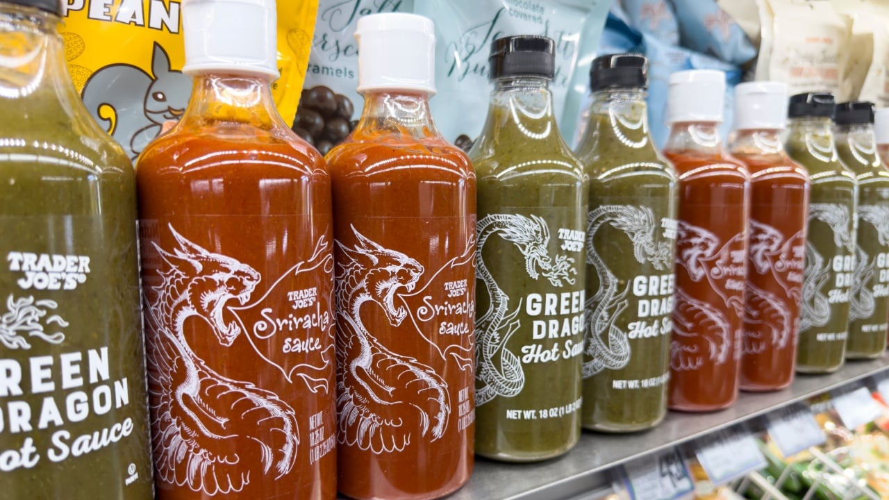 Los Angeles, California, United States - 08-14-2024: A view of several bottles of Trader Joe's sriracha and Green Dragon hot sauce.