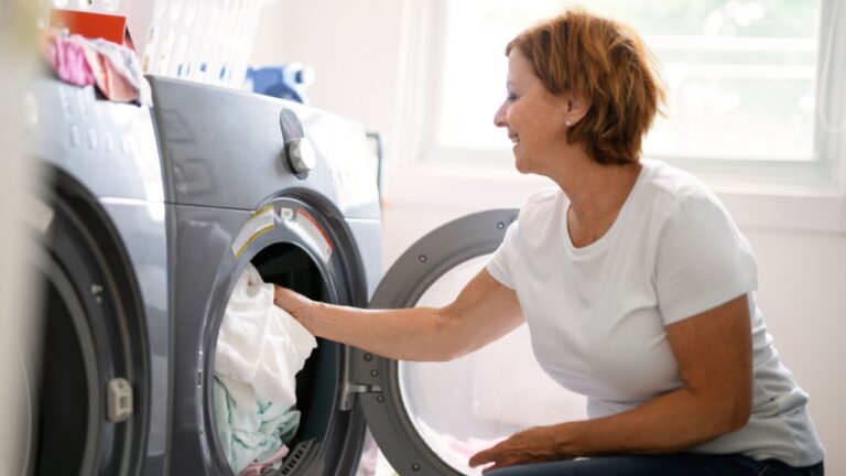 A senior Woman Doing Laundry near a Washing Machine