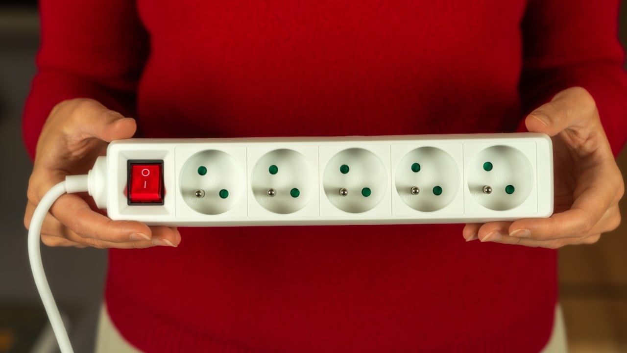 White european power strip with six schuko outlets and Illuminated on-off switch Isolated on white background for home office and electrical connectivity needs.