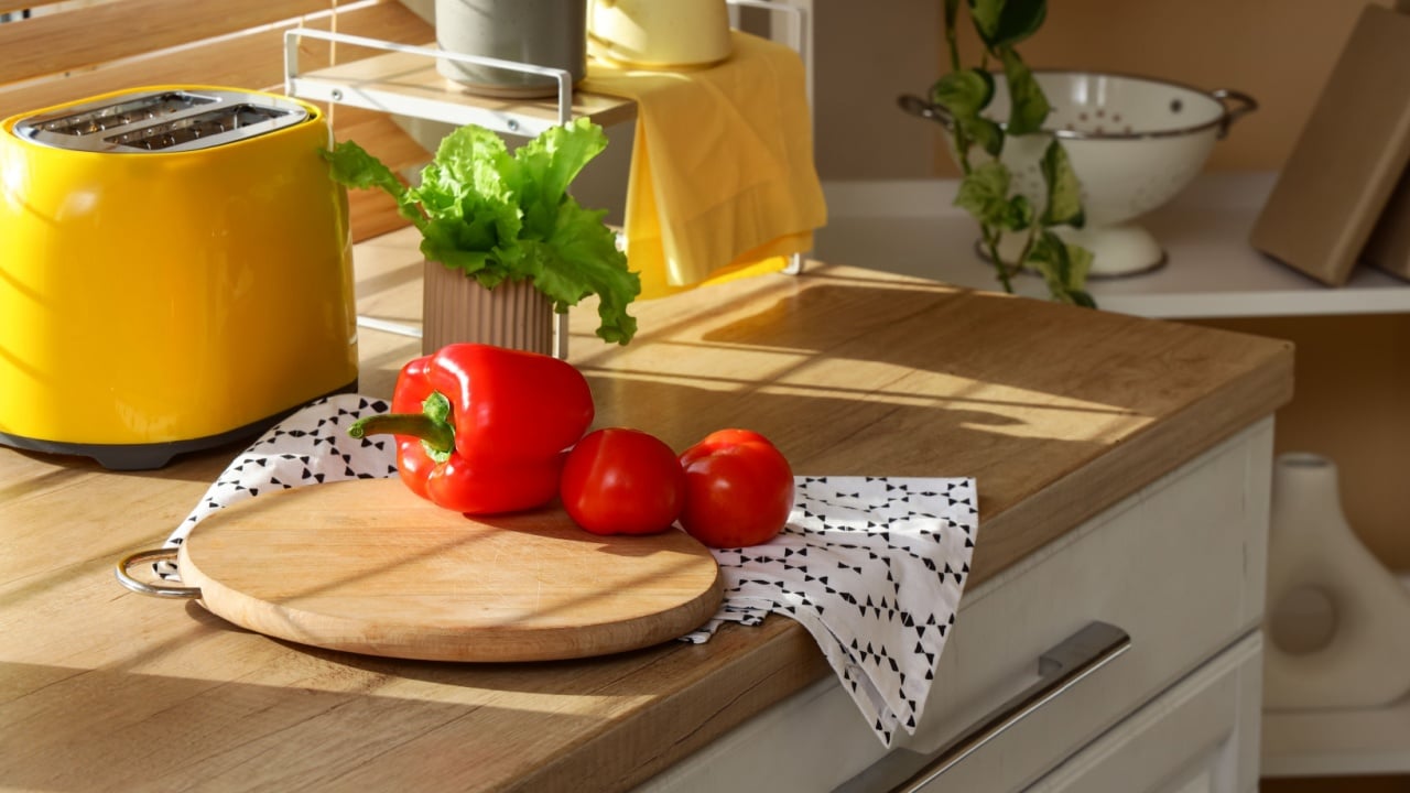 Cutting board with vegetables and napkin on counter in kitchen