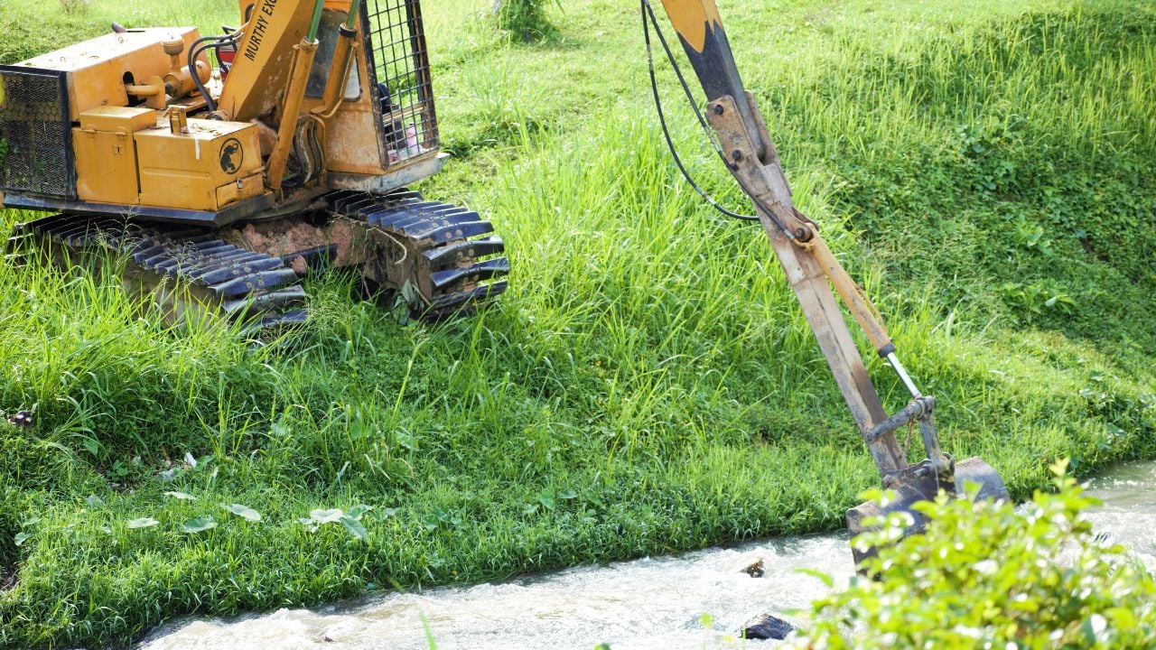 excavator near creek bank