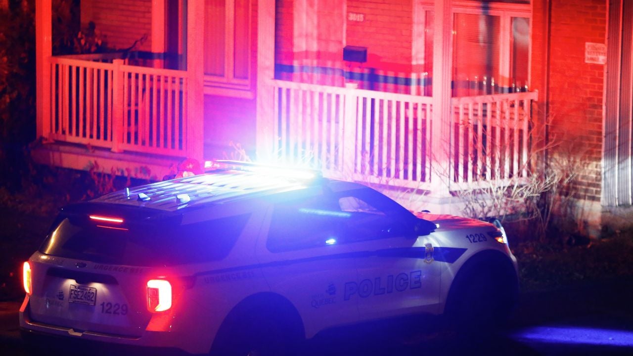 police car outside suburban home at night burglary investigation